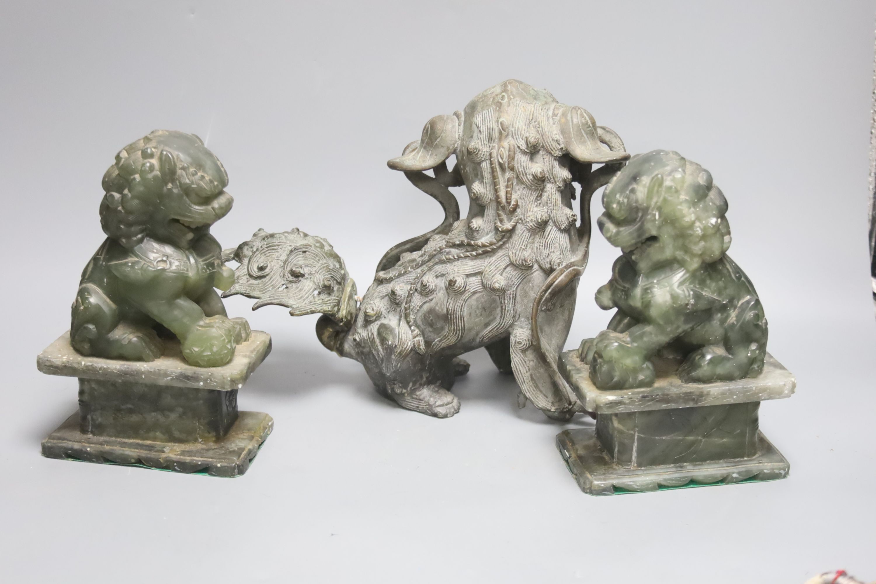 A South East Asian bronze shi-shi dog, 19cm high, a pair of soapstone temple dogs and hardstone grapes